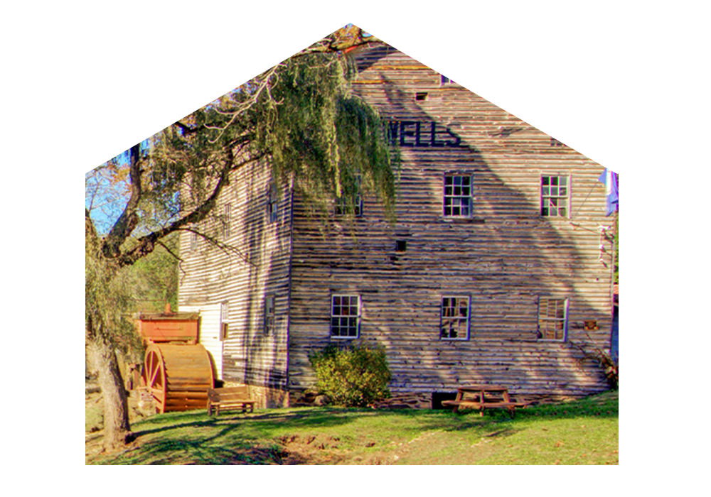 View of a mill next to a waterfall