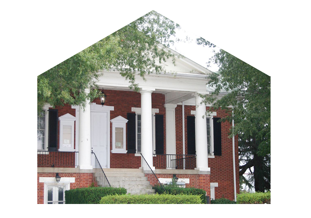 Photo of brick courthouse and shrubbery surrounding the building