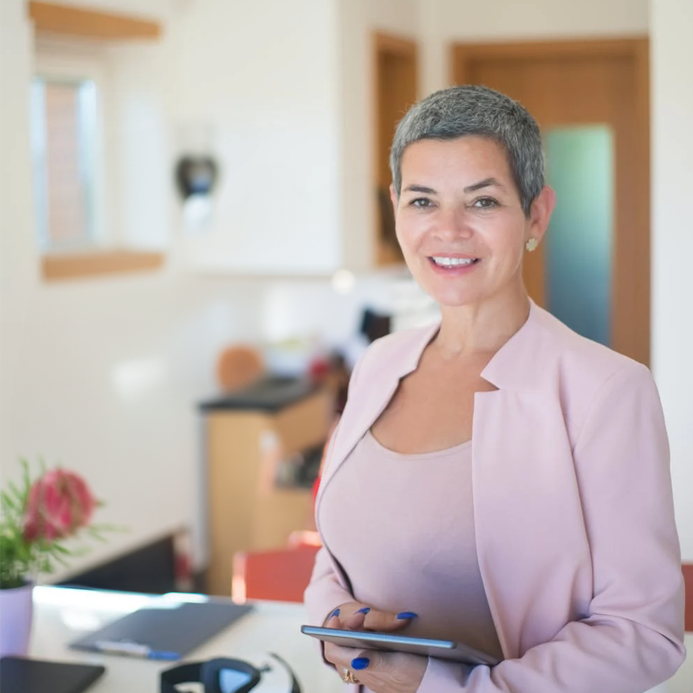 woman in pink suit standing in a kitchen